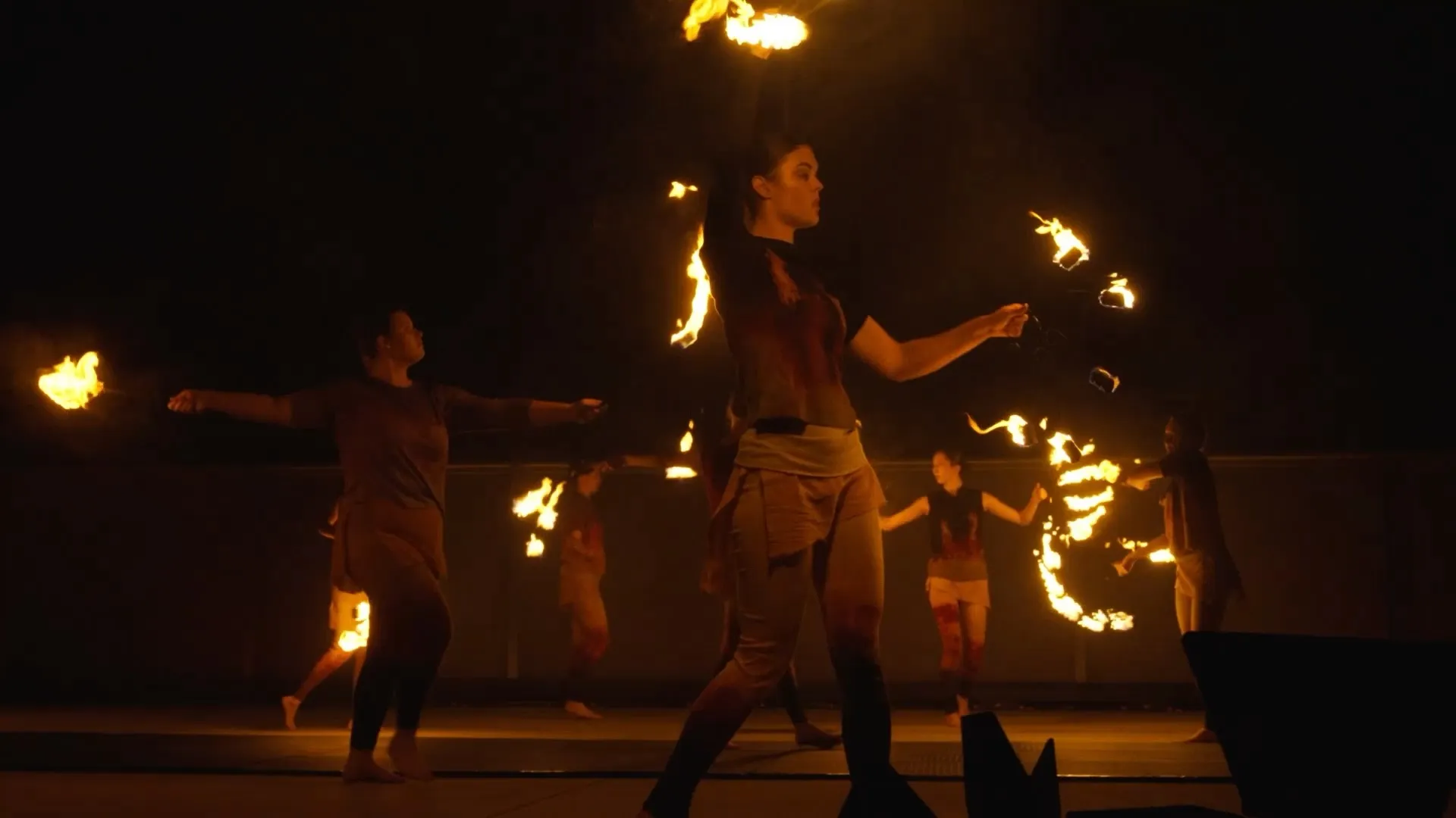 A photo of a woman dancing with fire.